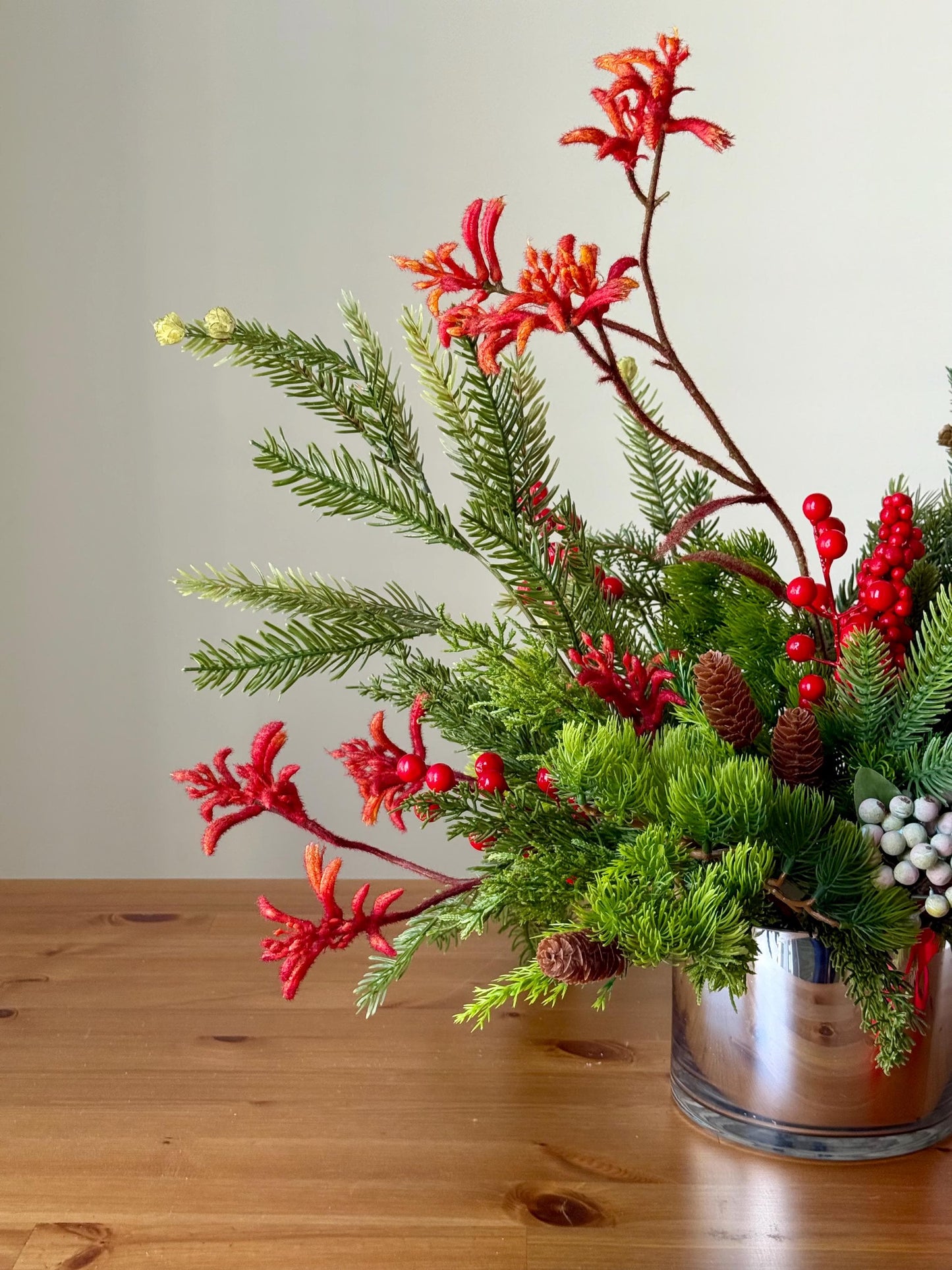 Artificial Christmas Centerpiece with Pine Greenery Berries and Red Ribbon in Glass Vase