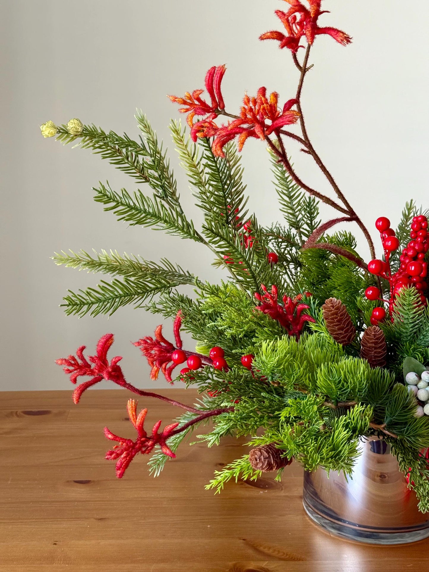 Artificial Christmas Centerpiece with Pine Greenery Berries and Red Ribbon in Glass Vase