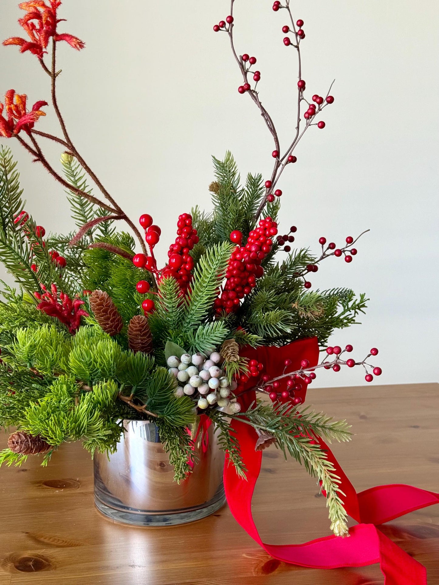 Artificial Christmas Centerpiece with Pine Greenery Berries and Red Ribbon in Glass Vase