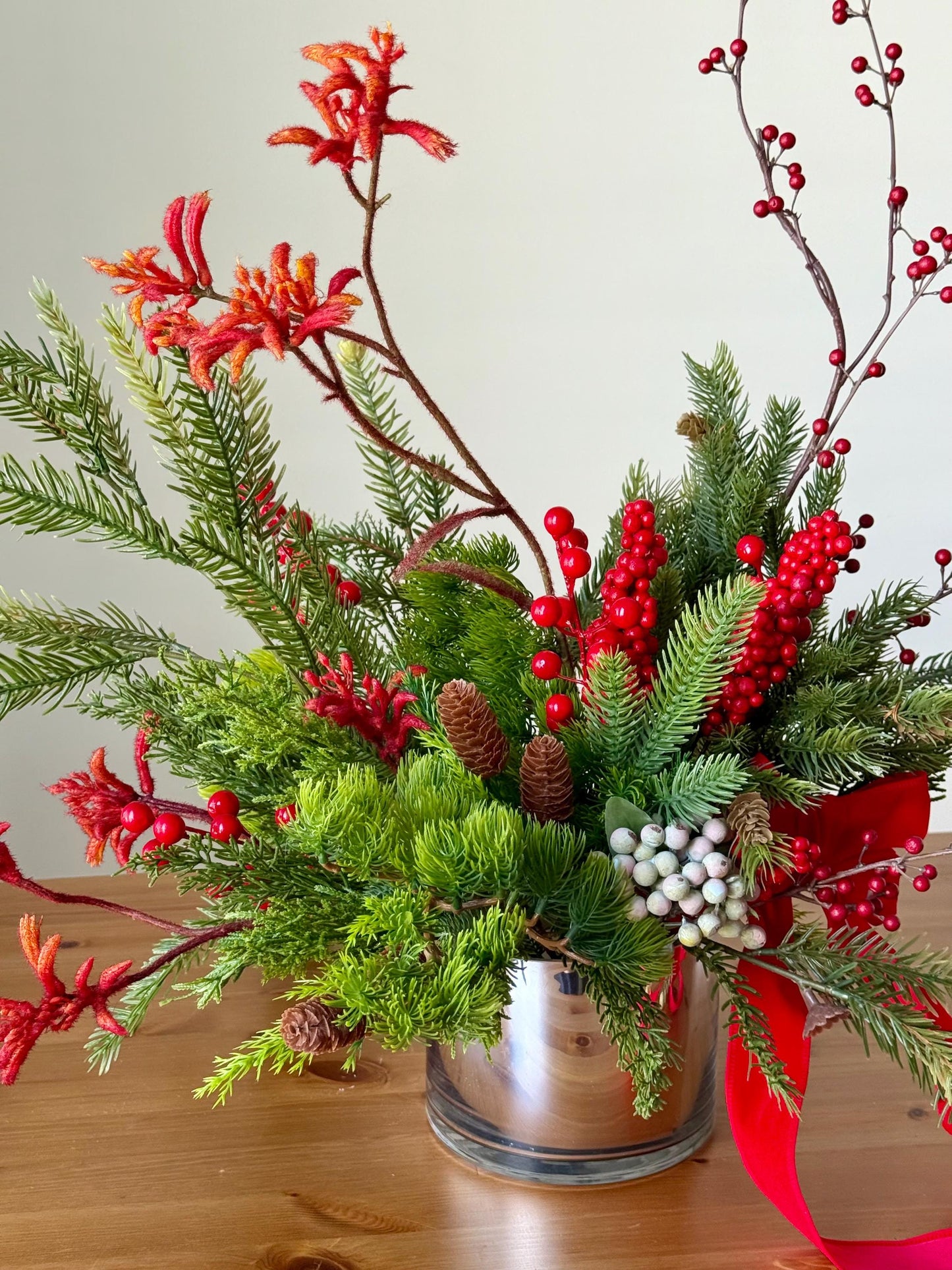 Artificial Christmas Centerpiece with Pine Greenery Berries and Red Ribbon in Glass Vase